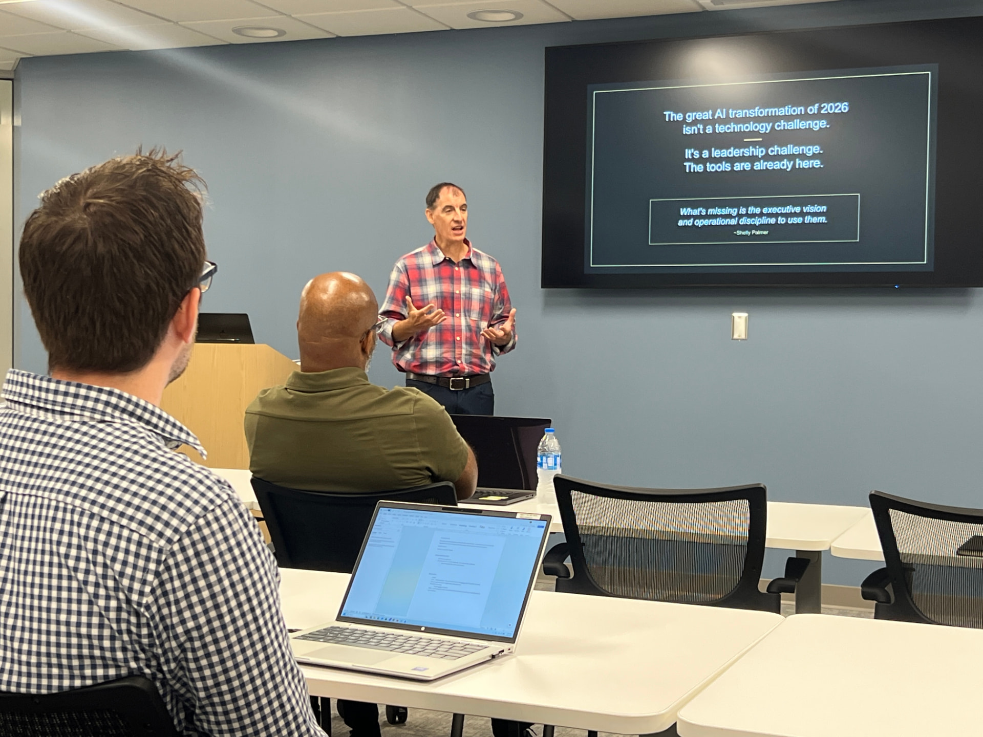 Tim Holmes presenting at a navigating ai session: the great ai transformation isn't a technology challenge